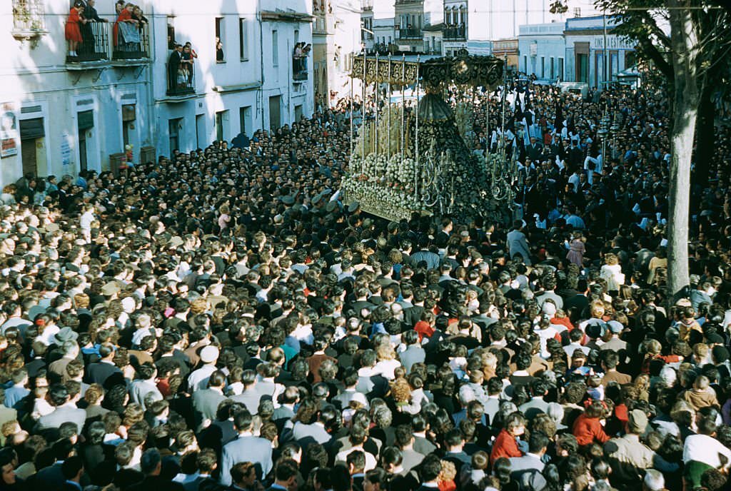 A crowded street procession probably in Spain, 1960.
