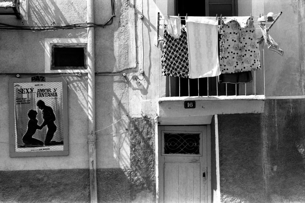 Laundry hanging from a window and movie poster 'Sexy amor y fantasia' on September 4, 1977, Villajoyosa in Spain,