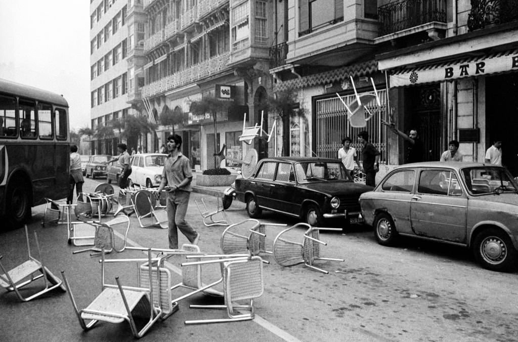 Basque protestors demanding autonomy for the Basque Country attempt to create a street barricade by throwing cafe tables and chairs onto the road in San Sebastian, Spain, 1st September 1979.