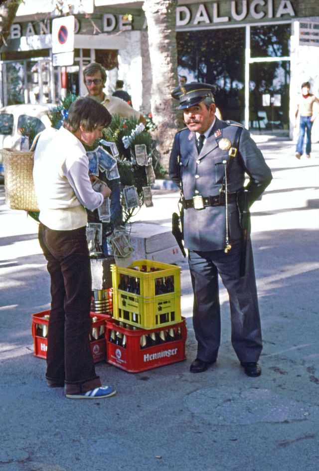 Money on the Christmas tree and beer in plastic crates are gifts to local policeman, Almuñécar, 1977