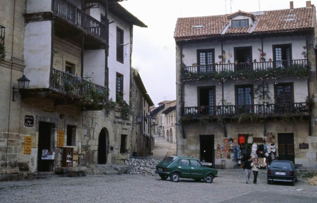 Cows walking down a street in Santillana del Mar, Cantabria, Spain, 1985.