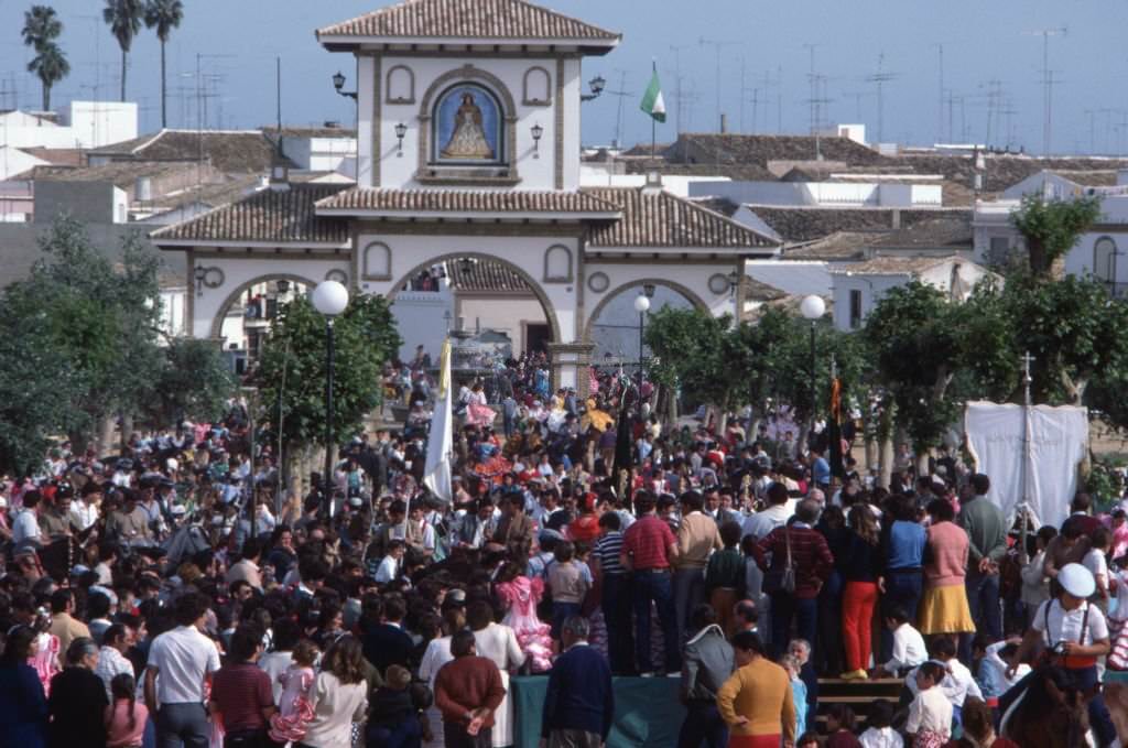 Crowd attending outdoor mass during the El Rocío pilgrimage, in Almonte, in 1983, Spain.