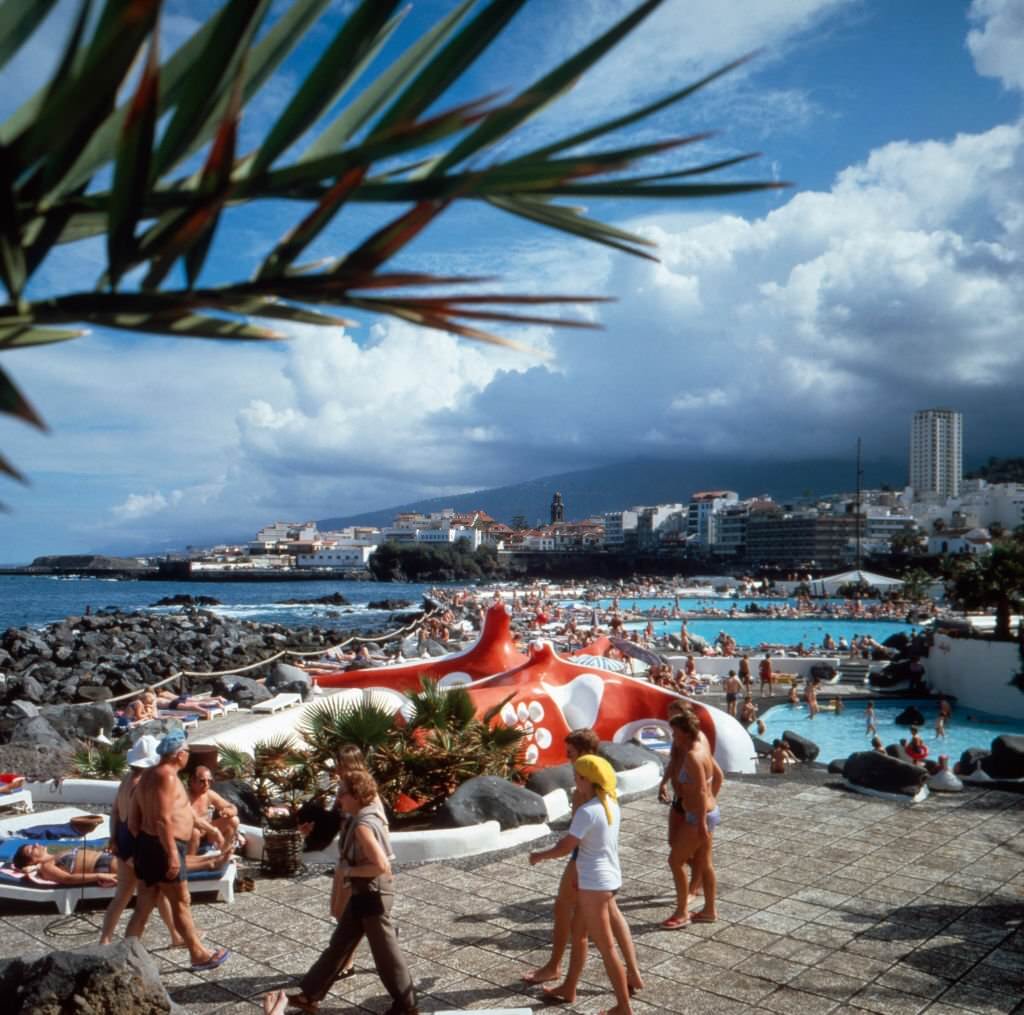Tourists at sea swimming pools at Puerto de la Cruz on Tenerife, Spain 1980s.