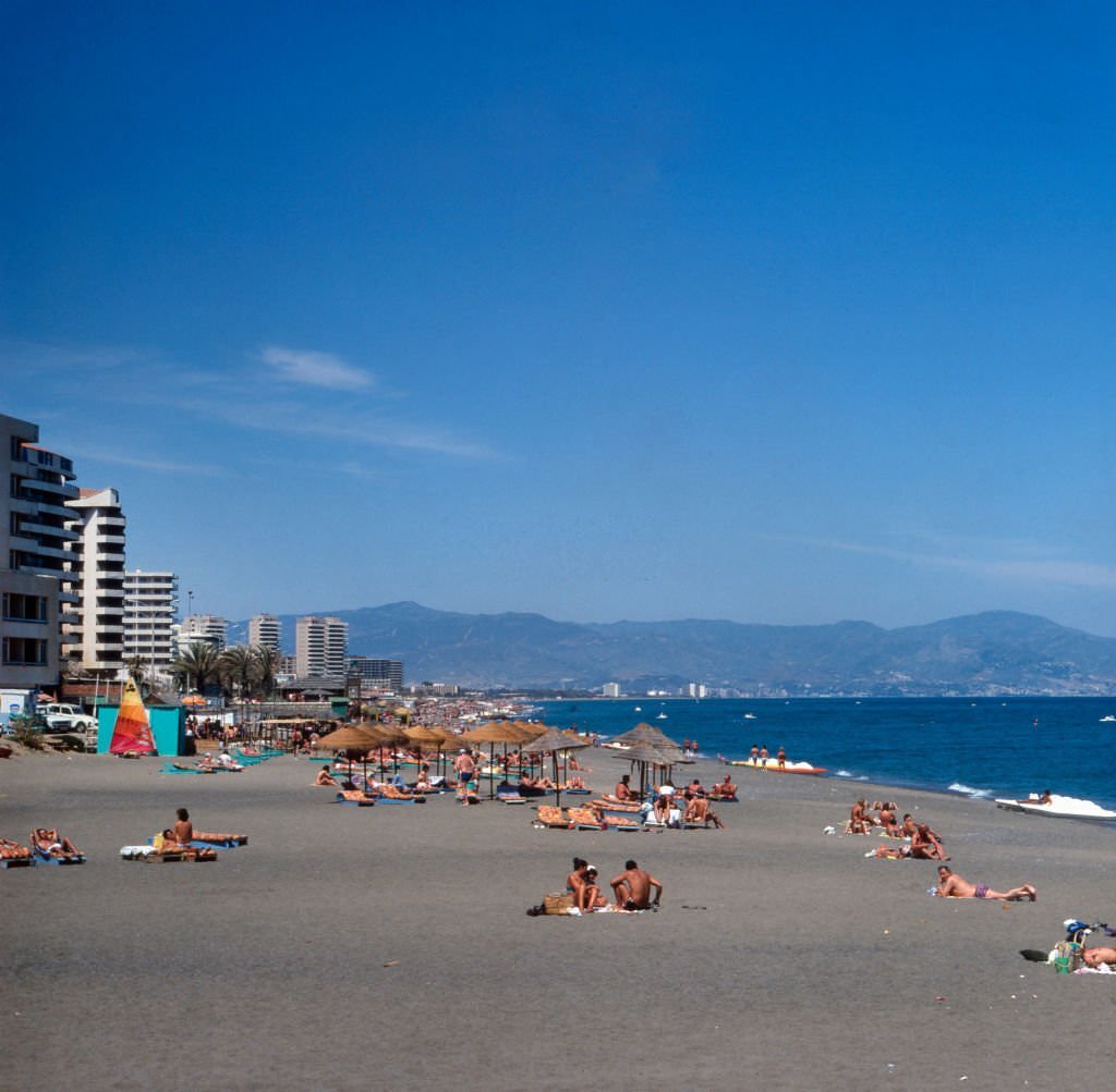 Tourists at the beach of Torremolinos, Spain 1980s.