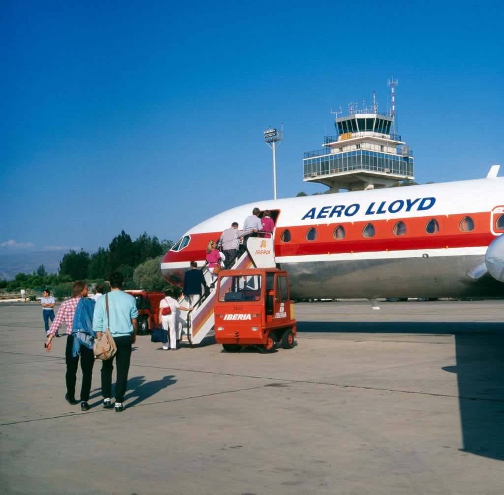 Passengers enter a plane of Aero Lloyd at Almeria airport, Spain 1980s.