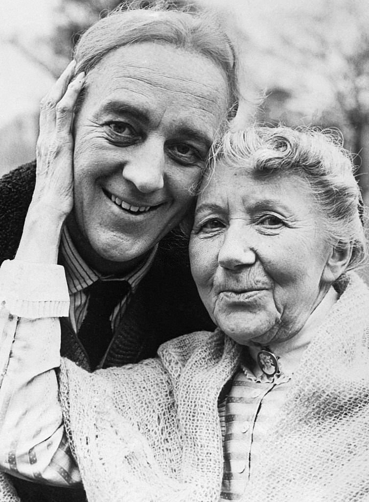 British actor Alec Guinness cuddles in London with his new leading lady, Katie Johnson, who came out of retirement for her first starring role at the age of 76.