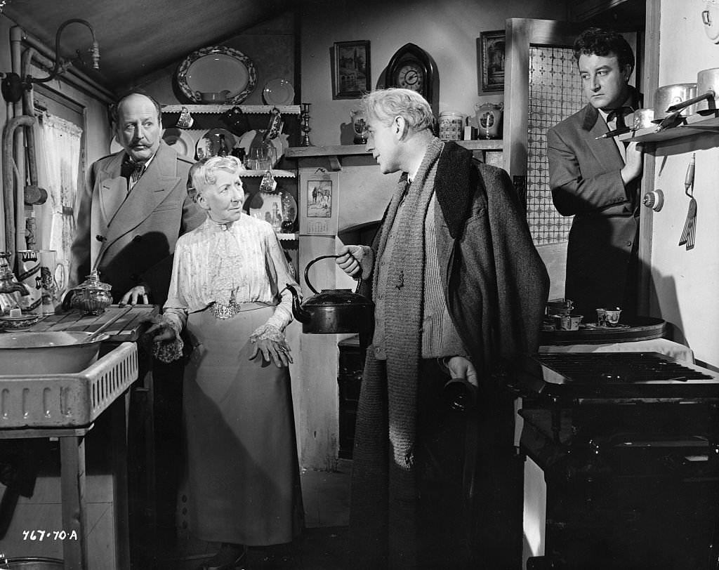 Professor Marcus (Alec Guinness) tries to convince Mrs. Wilberforce (Katie Johnson) that he had a good reason for participating in a robbery in the movie 'Lady Killers', 1955