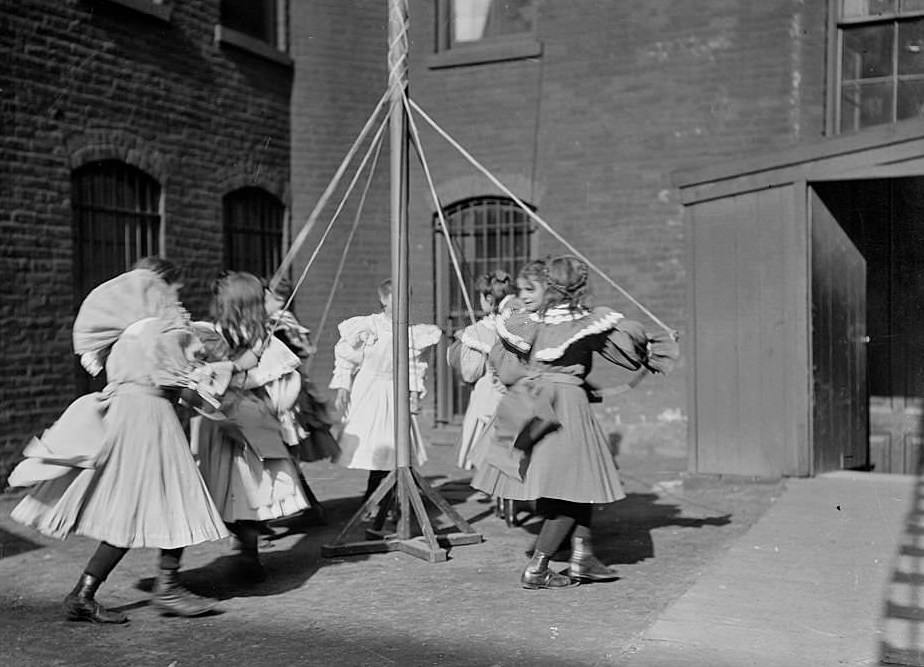Deaf girls dancing around a maypole in a schoolyard, Chicago, Illinois, May 8, 1903.