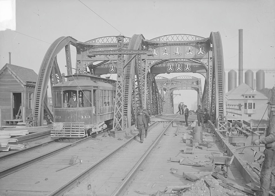 Streetcar driving on one lane of the Ninety-fifth Street Bridge, spanning the Calumet River in the South Chicago community, while construction work is being done, Chicago, Illinois, March 19, 1903.