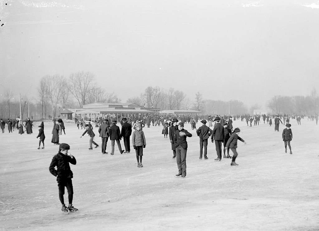 Large crowd of people ice skating on the frozen lagoon at Jackson Park in the Woodlawn community area of Chicago, Illinois, 1903.