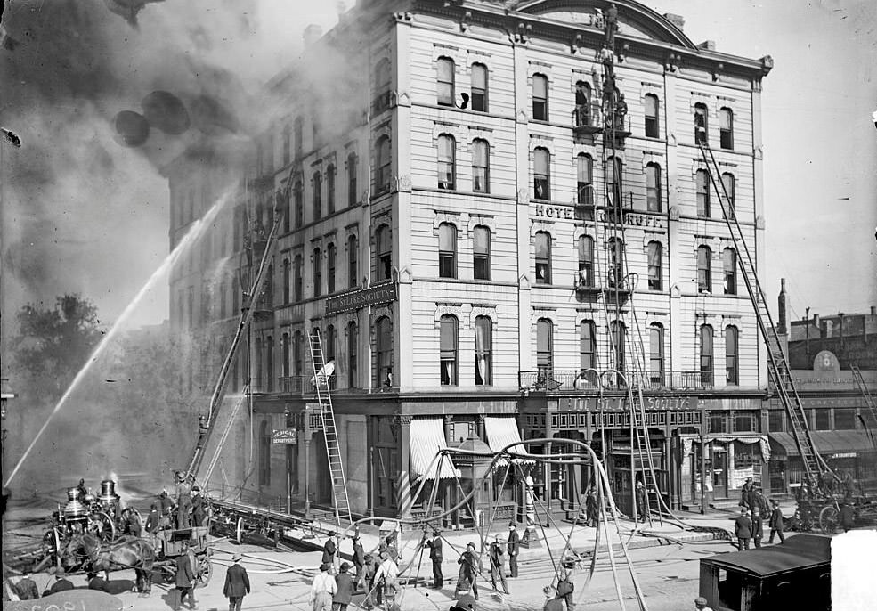 Hotel Woodruff on fire with firemen and fire extinguishing equipment on and around the building, Chicago, Illinois, June 19, 1902.
