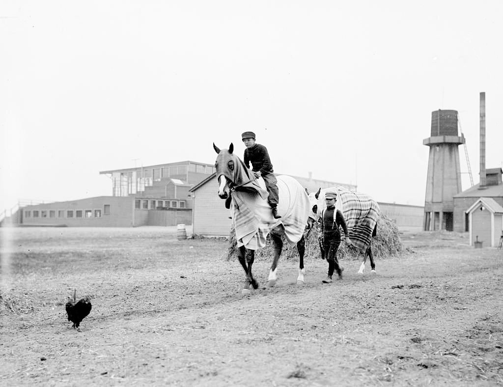 Image of jockey John Oaks, mounted on a racehorse named Charles Walker, in Chicago, Illinois, 1902.