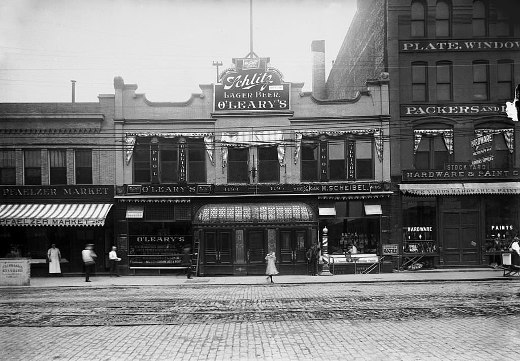 Exterior view of O'Leary's saloon with neighboring buildings partially visible and merchants and pedestrians on the sidewalk, Chicago, 1906.