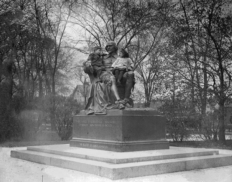 Children sitting in the lap of the William Shakespeare statue, located at the foot of West Belden Avenue in Lincoln Park, in the Lincoln Park community area, Chicago, 1900s