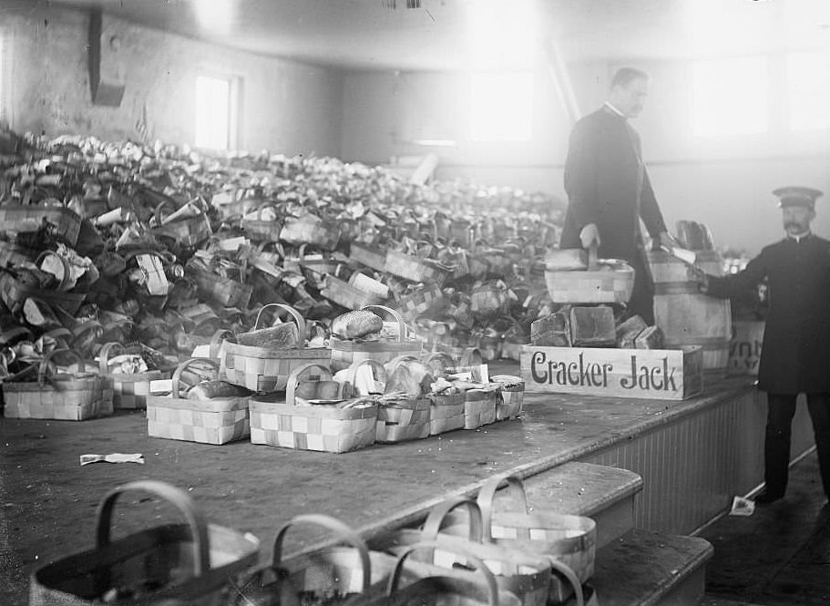 View of Salvation Army food baskets piled up on a stage at Christmas, Chicago, Illinois, 1900s.