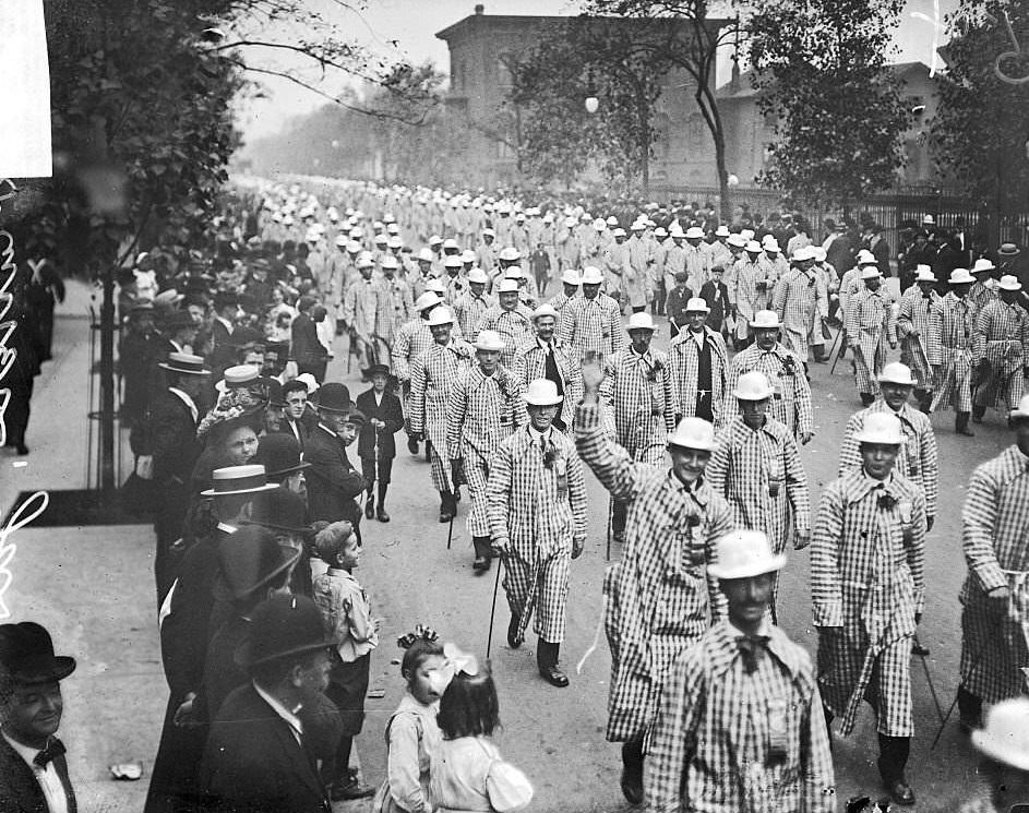 Meat cutters wearing checkered overcoats marching in a Labor Day parade in Chicago, Illinois, 1900s.