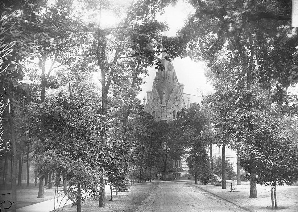 Exterior view of University Hall at Northwestern University, looking down a path leading toward the building, Evanston, Illinois, 1900s.