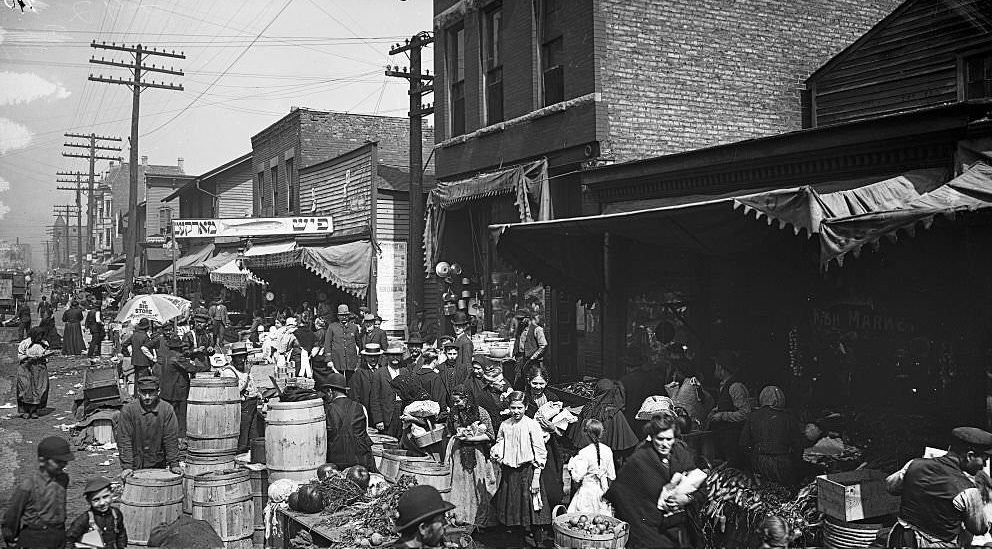 View of vendors and shoppers on Jefferson Street in the Maxwell Street Market area, Chicago, Illinois, 1905