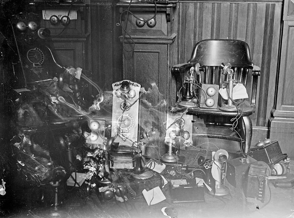 Telephones on chairs and on the floor during a bucket shop raid, Chicago, Illinois, 1905