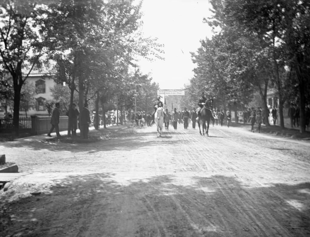 View down street of German soldiers on a march from the depot of the Chicago, Milwaukee, and St Paul Railroad on their way to Turner Hall, June 17, 1900.