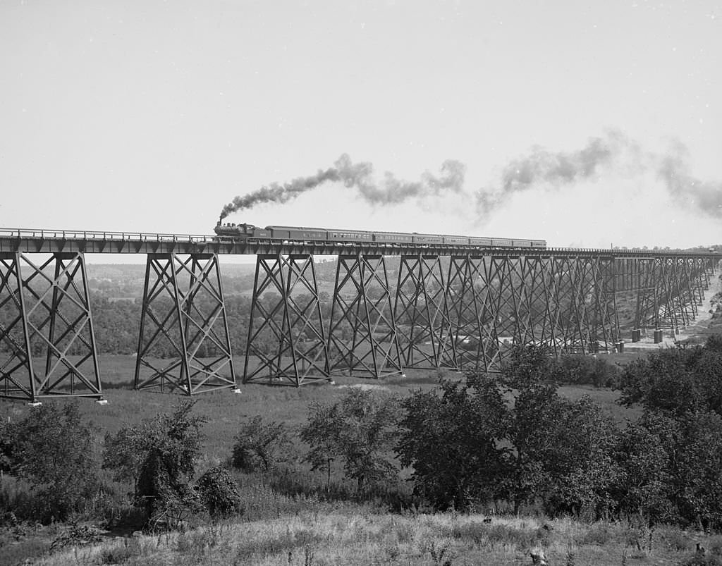 Steam locomotive & Train passes over Valley Trestle Bridge -Chicago & North Western Railway viaduct over Des Moines River, 1900s