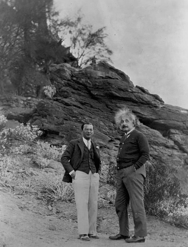 Albert Einstein and Man Standing on Desert Hillside
