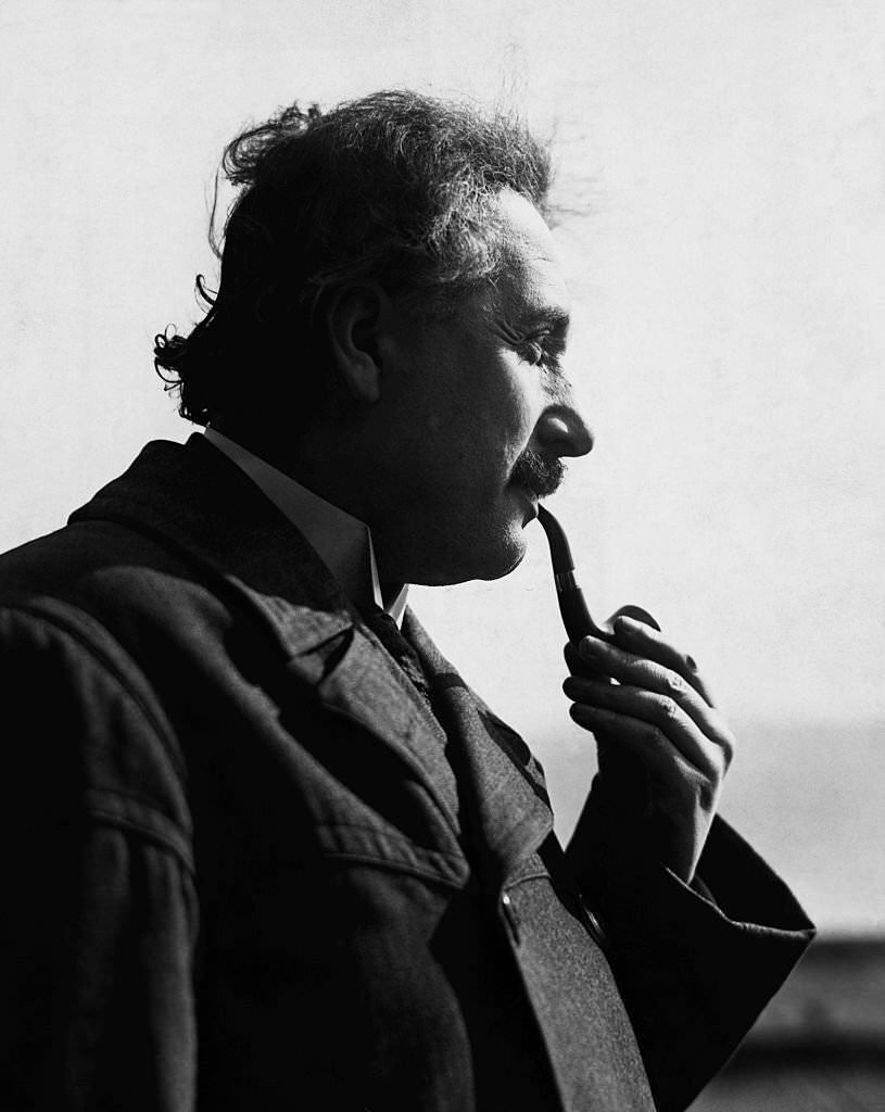 Albert Einstein smoking pipe in profile photograph.