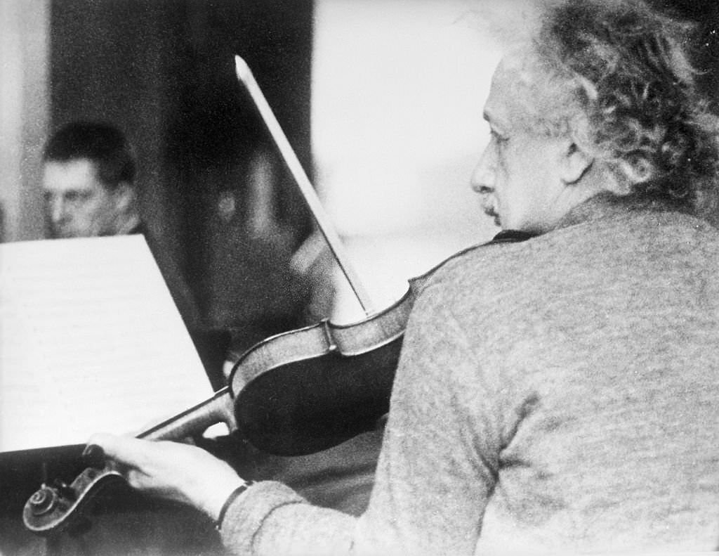 Albert Einstein playing the violin at a chamber music rehearsal in Princeton.