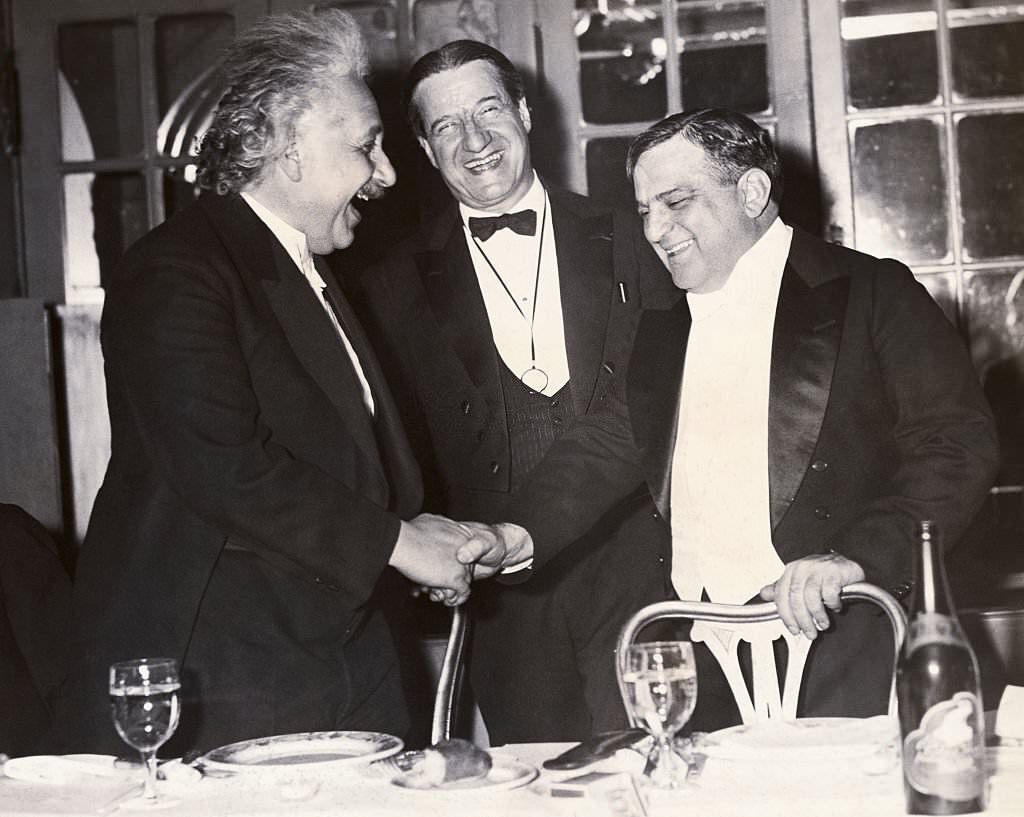 Einstein shakes hands with Mayor Fiorillo LaGuardia while Rabbi Stephen Wise looks on.