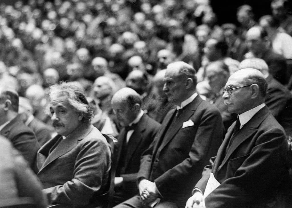 Albert Einstein at the general assembly of the German Bunsen Society. Behind Einstein: Max Planck, 1928