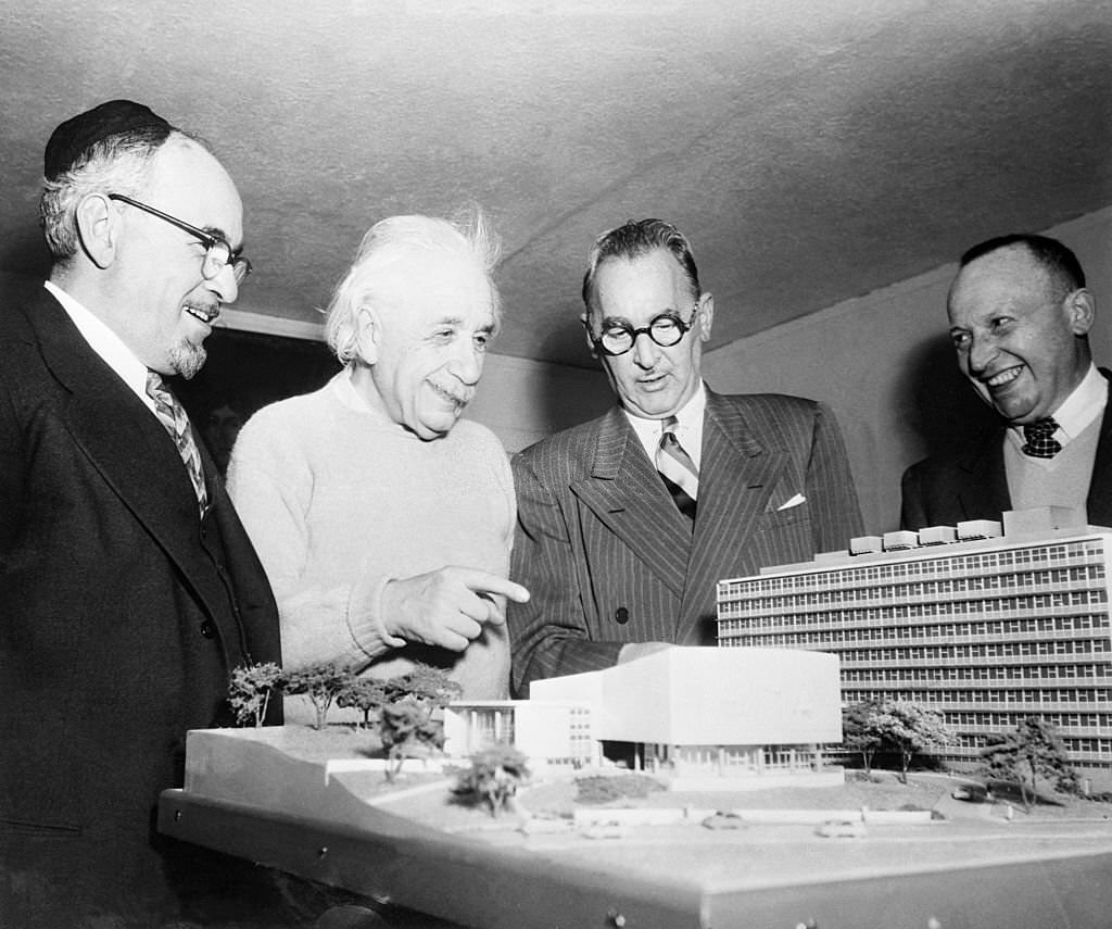 Albert Einstein is shown as he received a scale model of the Albert Einstein College of Medicine of Yeshiva University, now under construction in New York City