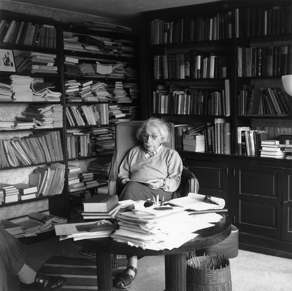Albert Einstein ponders a problem in his paper-filled study in Princeton, New Jersey, 1951.