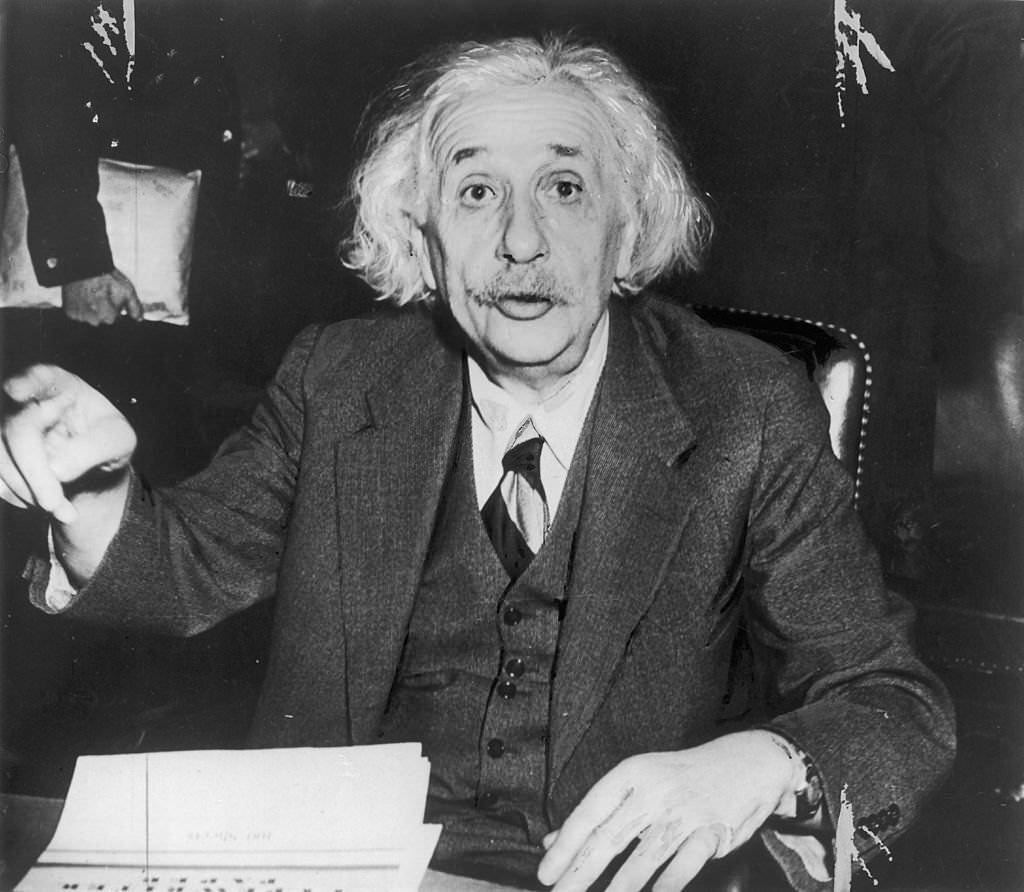 Albert Einstein leaving the hearing of the Anglo-american commission in Washington D.C. and complaining about the glare of the photographers bulbs.