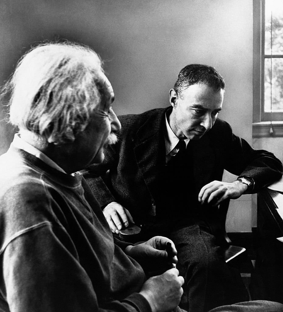 Einstein with Dr. Robert Oppenheimer, right, director of the Institute for Advanced Study, listens intently to a discussion by Dr. Albert Einstein regarding matter in terms of space.