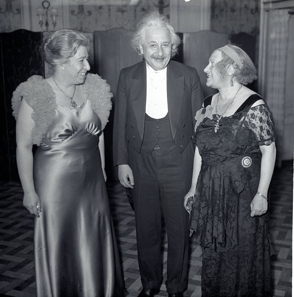 Professor Albert Einstein with his wife, Elsa Einstein (right), and Mrs. Theresa M. Durlach, president of the World Peaceways Organization, at the dinner held in the Hotel Roosevelt in commemoration of the 100th anniversary of the birth of Alfred Bernard Nobel