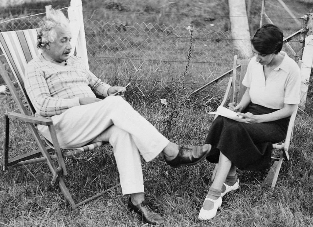 Albert Einstein dictates to his secretary, long in his employ, Fräulein Helen Dukas, at Coq-sur-Mer, Belgium.
