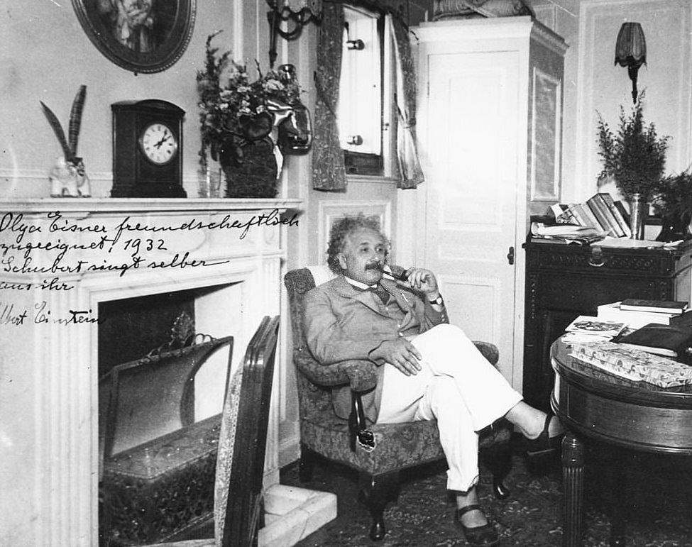 Albert Einstein sitting in an armchair and smoking a pipe, 1932.