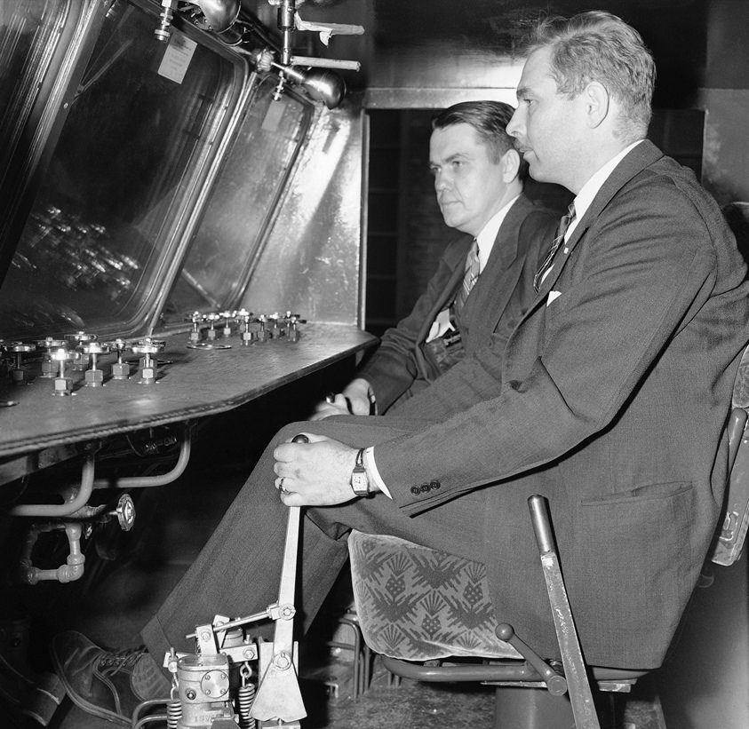 The controls of the snow cruiser, with Dr. F. A. Wade (foreground), chief scientist of the U.S. Antarctic service, and Harold Vagtborg, director of the Armour Institute of Technology Research Foundation.