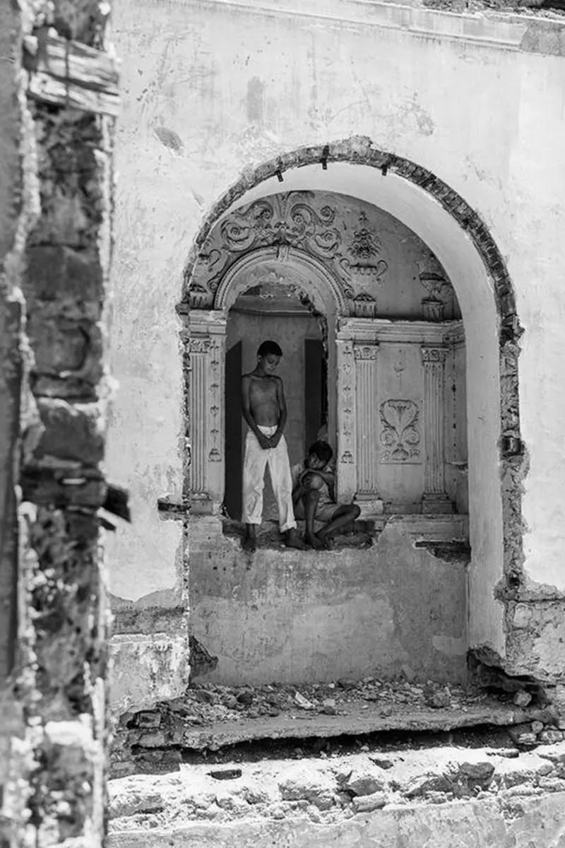 Boys play in a crumbling building.