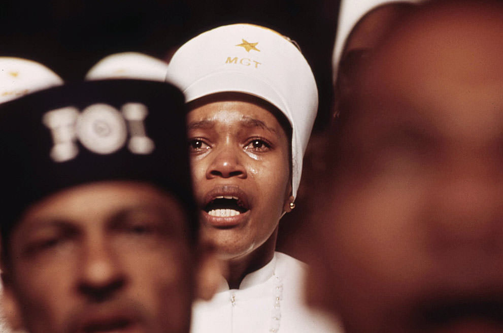Religious fervor is mirrored on the face of a Muslim woman listening to Elijah Muhammad’s Savior’s Day Message in Chicago, March 1974.