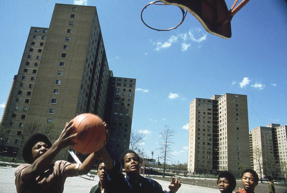 Youths play basketball at Stateway Gardens highrise housing project on the South Side, May 1973.