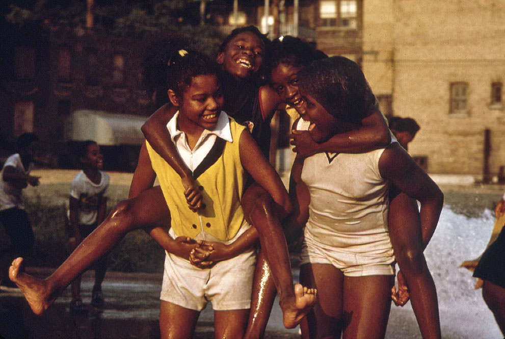 Youngsters cool off with fire hydrant water in the Woodlawn Community, June 1973.