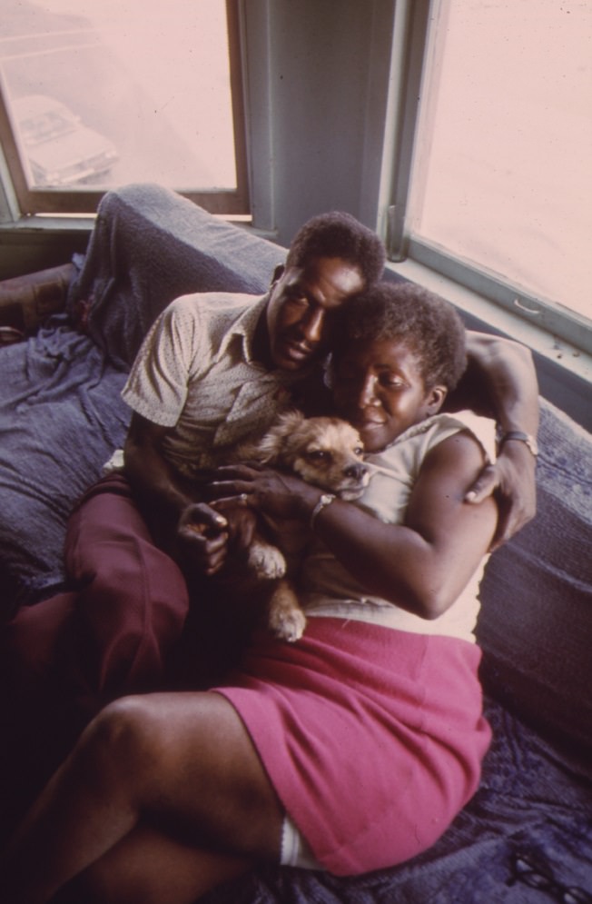 A couple and their dog in their apartment in South Side Chicago.