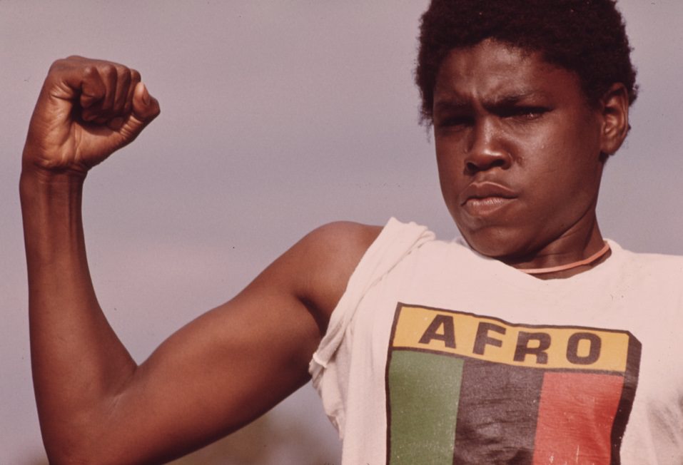 A young man showing his muscle during a small community program in Chicago in the South Side.