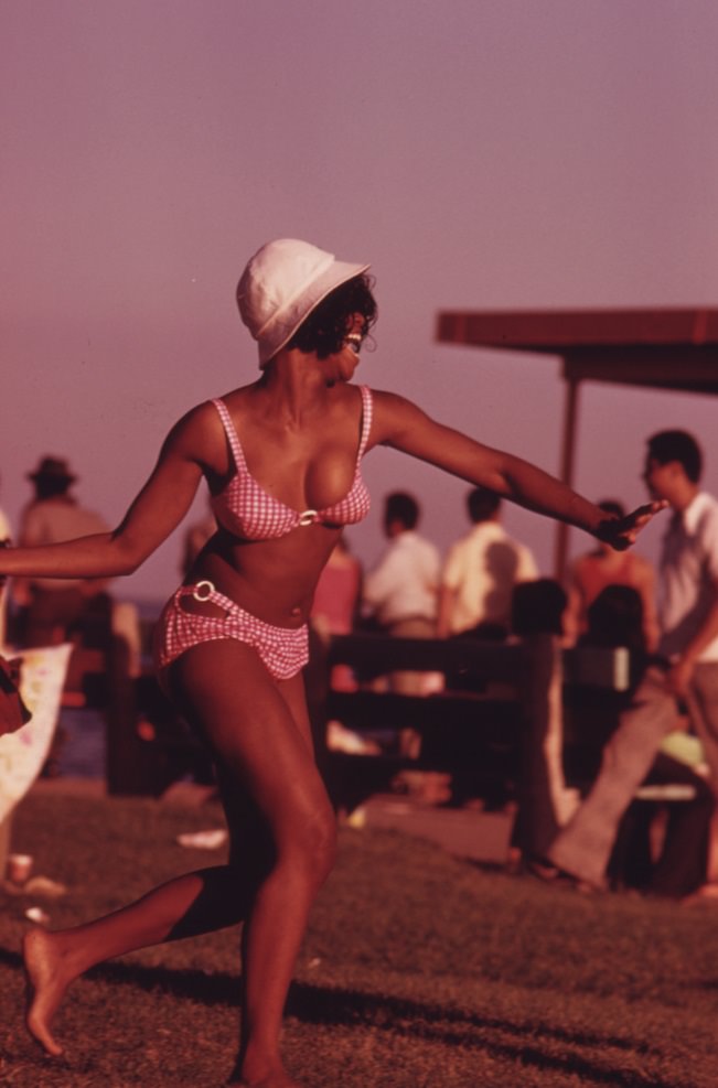A swimsuit-clad woman enjoys her summer outing at Chicago’s 12th Street Beach in Lake Michigan.