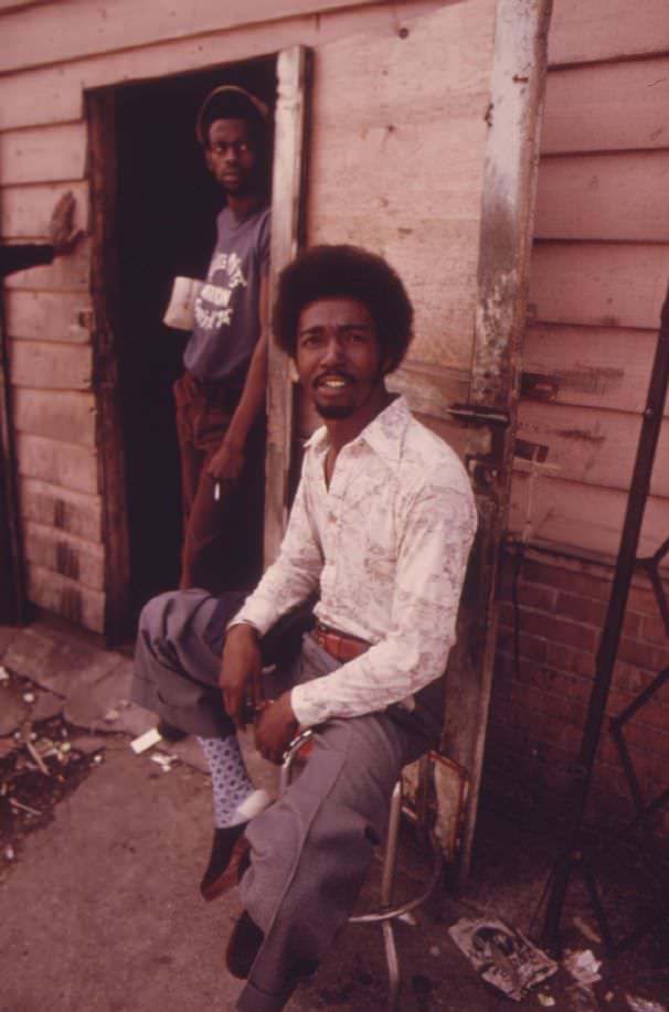 Black men at the entrance to a pool hall where they hang around Daily, located on Roosevelt Road in the heart of the ghetto on Chicago’s West Side.