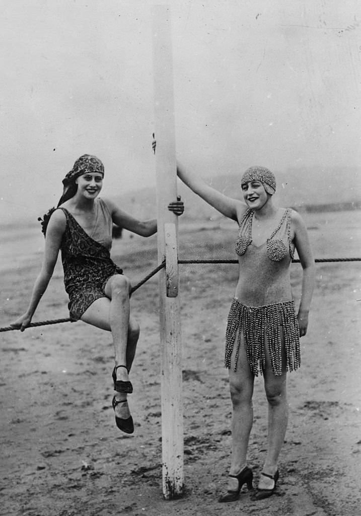 Two women modelling bathing suits on the beach at Deauville, 1926