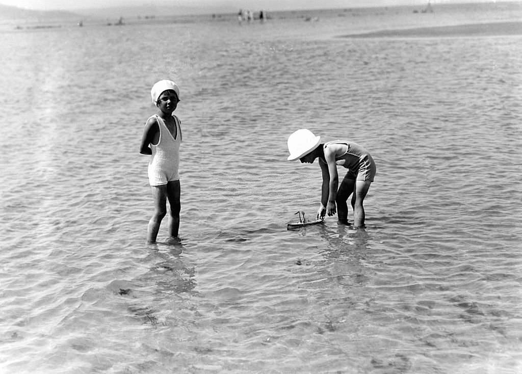 Young children playing on the beach in July 1929 in Deauville, France.