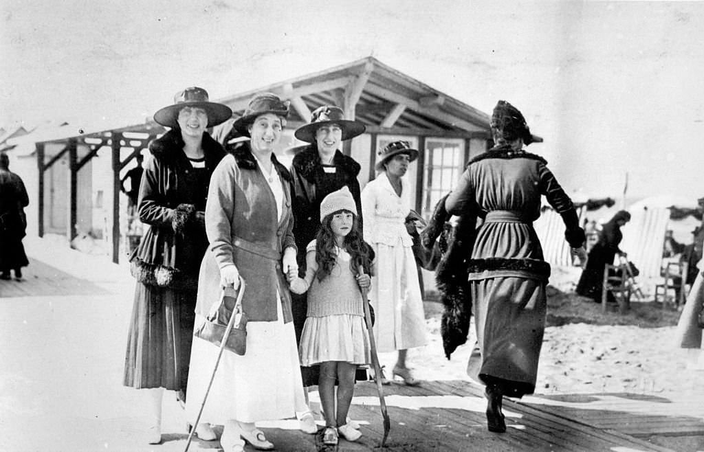 Sea bathings in Deauville, Women and a child having a walk on a beach in Deauville.