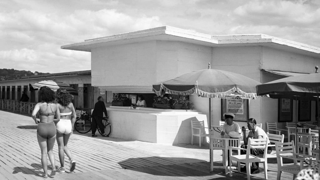 Customers eat ice cream on the terrace of a bar, installed in a converted blockhouse, on July 26, 1947 in Deauville.